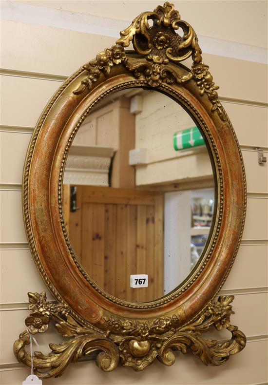 A late Victorian oval gilt gesso wall mirror 66 x 46cm